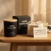A beautifully wrapped gift box with a ribbon sitting next to the luxury amber and sandalwood candle on a marble table.