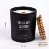 A hand holding the 150g glass candle jar to show its compact and portable size